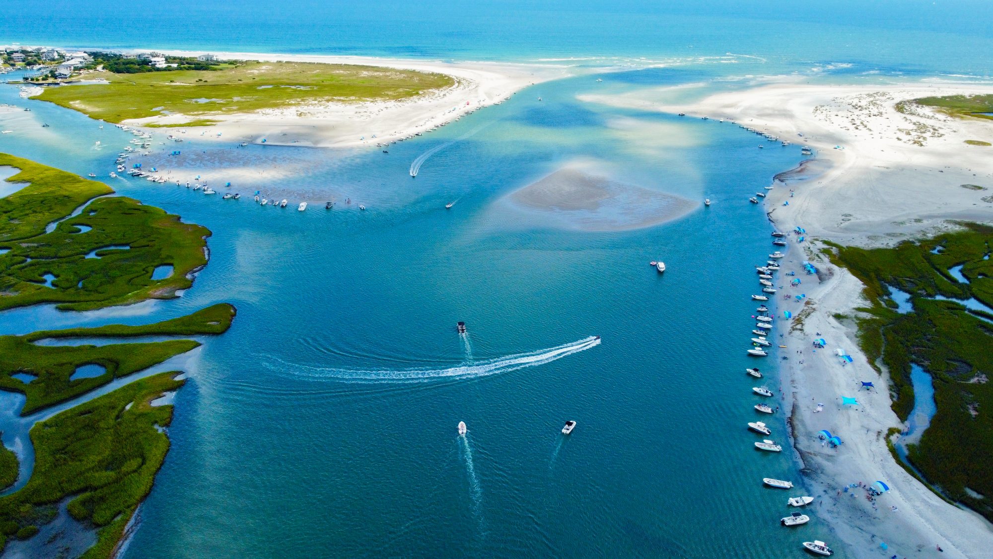 Boats gathered on the sandbars at Masonboro Inlet